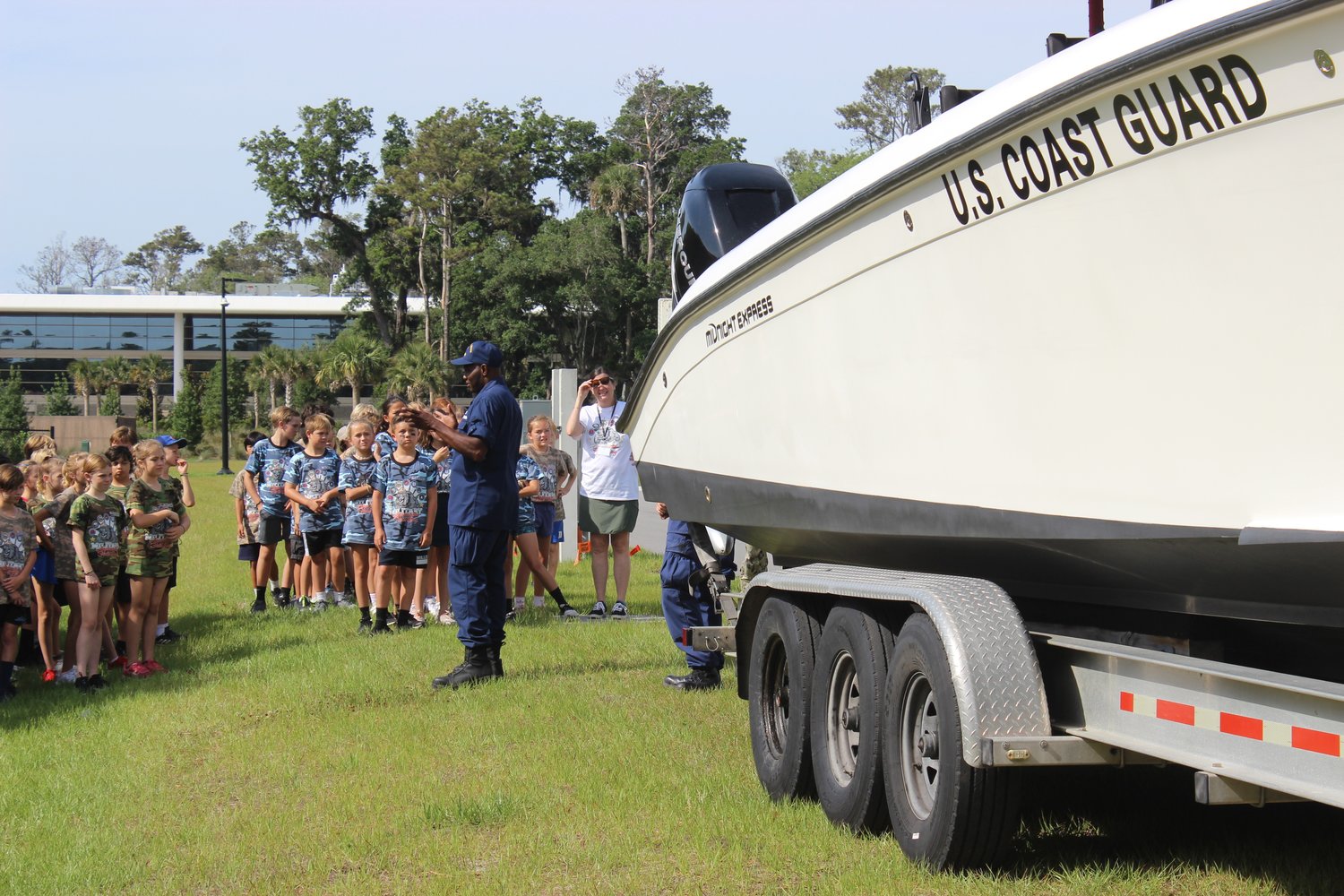 A member of the U.S. Coast Guard speaks to students from The Bolles Lower School Ponte Vedra Beach Campus.